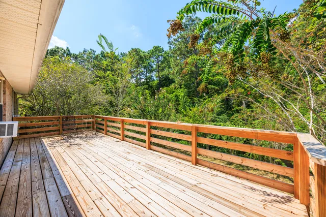 a view of balcony with wooden floor and fence