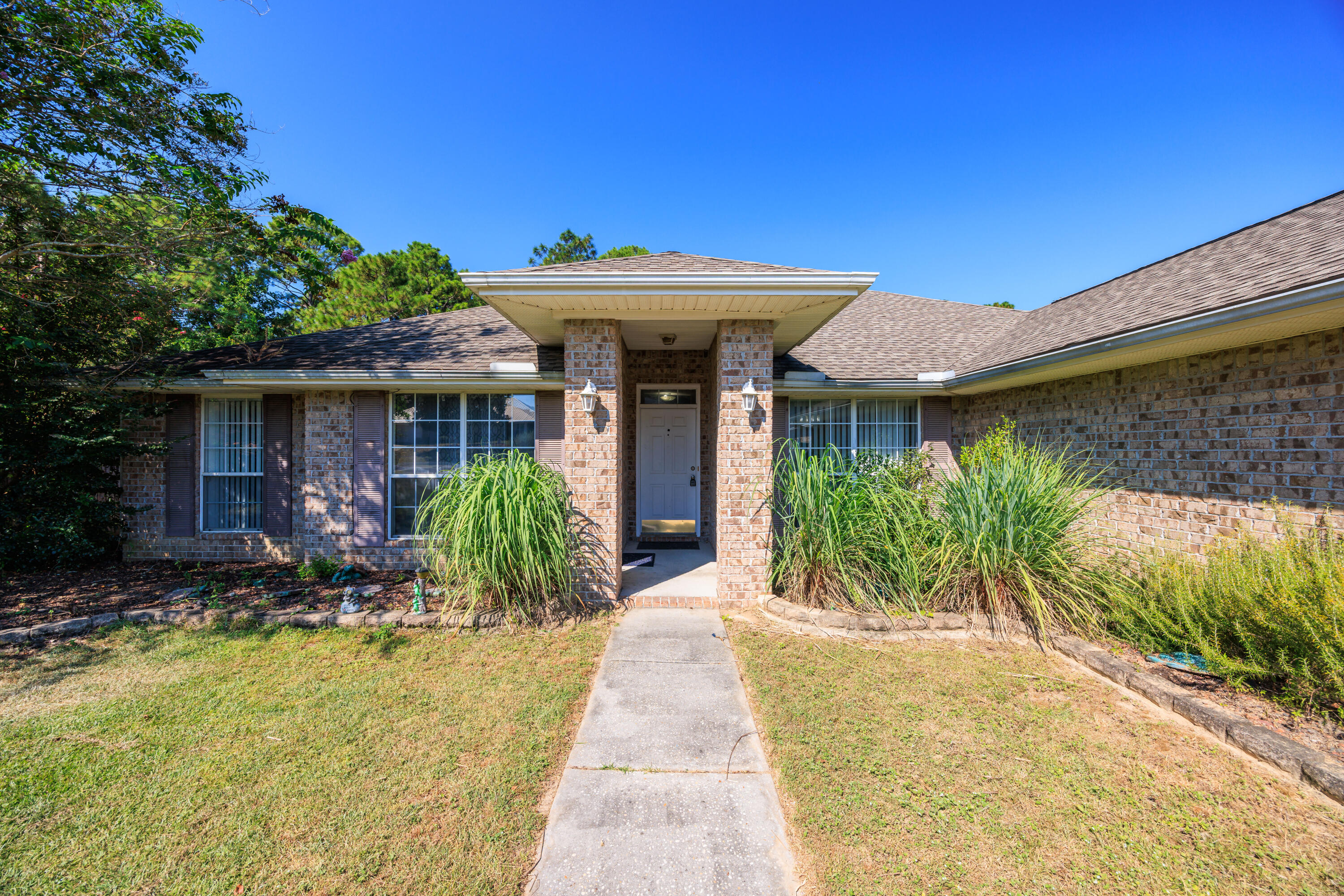 4860 Orlimar Street Crestview, FL 32536 - Photo 5 of 36 a view of a house with potted plants in front of it