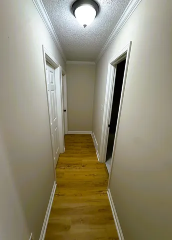 an empty room with wooden floor door and closet