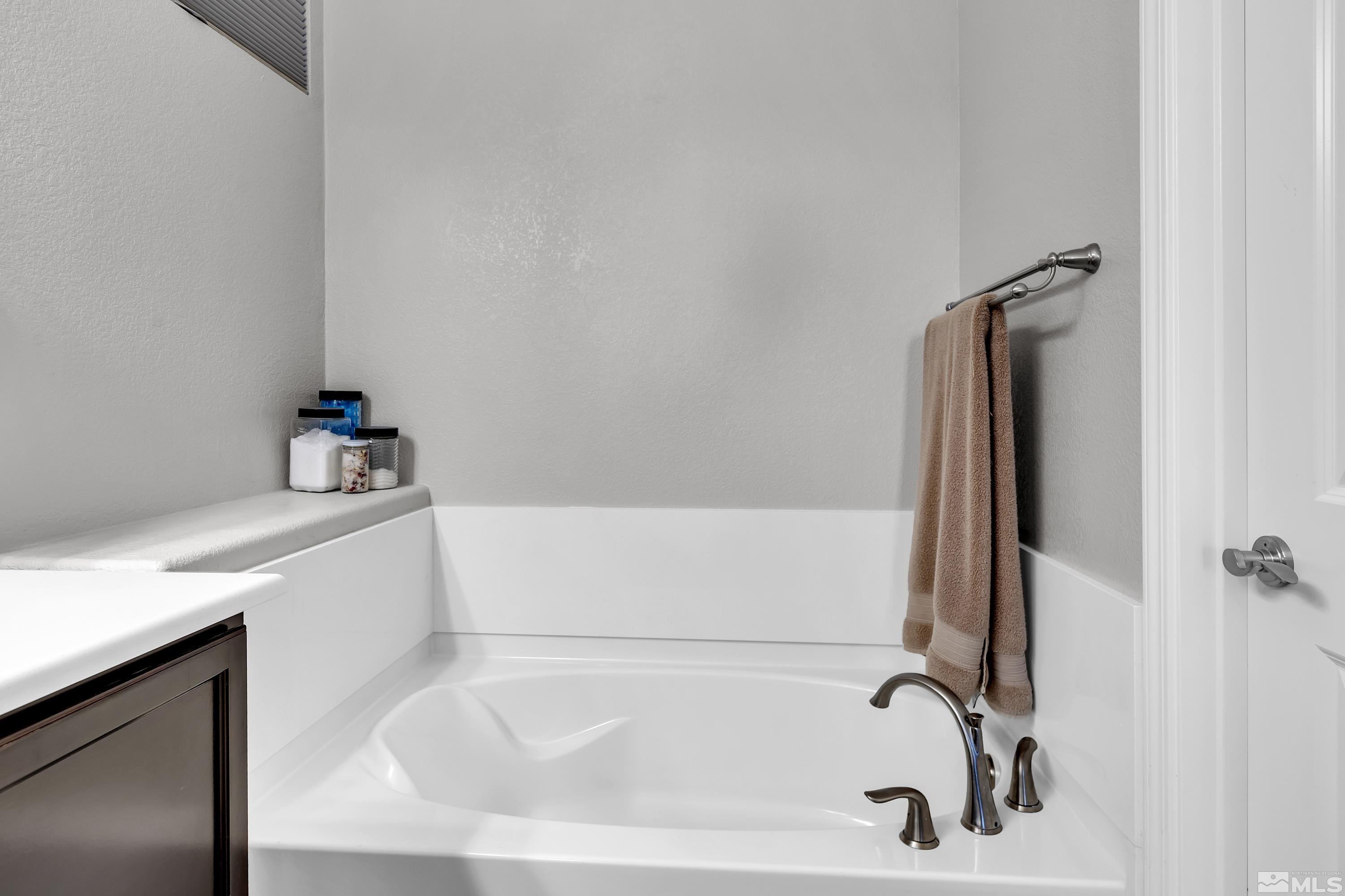 2255 Makenna Drive Reno, NV 89521 - Photo 15 of 34 a white bath tub sitting next to a white sink and vanity