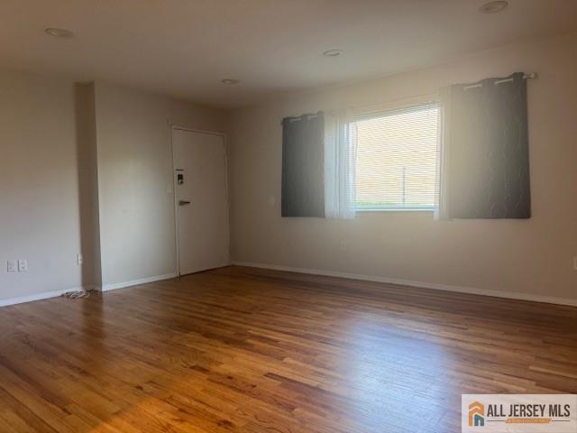 37 Judson Street Edison, NJ 08837 - Photo 2 of 11 an empty room with wooden floor and windows