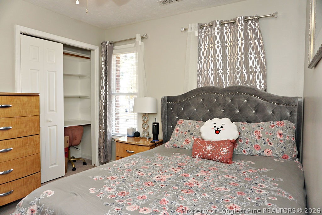 8363 King Road Fayetteville, NC 28306 - Photo 25 of 44 a bedroom with a bed and wooden floor