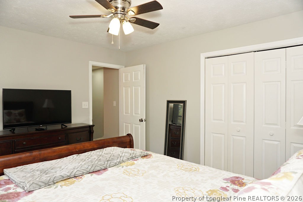 8363 King Road Fayetteville, NC 28306 - Photo 28 of 44 a bedroom with a bed and a flat screen tv