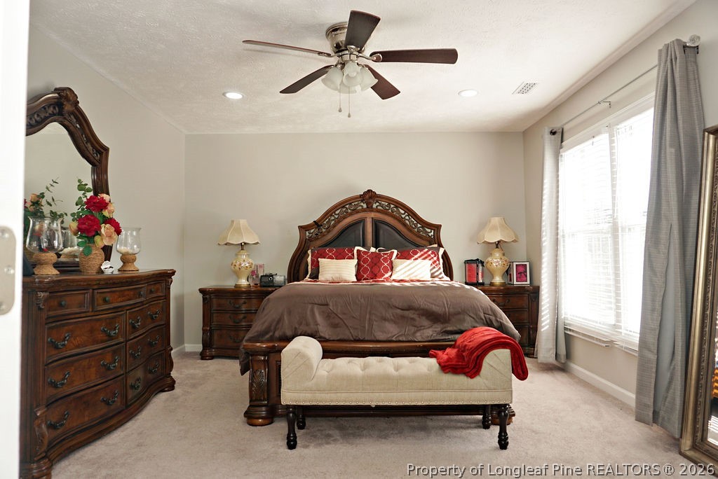 8363 King Road Fayetteville, NC 28306 - Photo 33 of 44 a bedroom with a bed and a chandelier