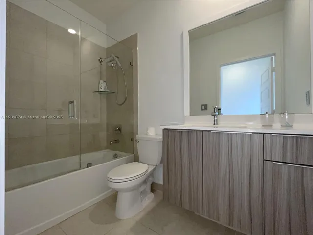 a bathroom with a toilet a sink and shower