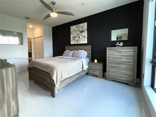 a bedroom with a bed and a mirror