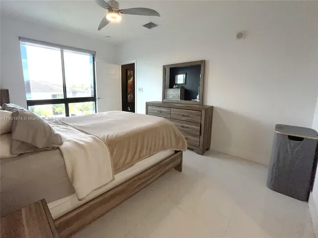 a bedroom with a bed and window