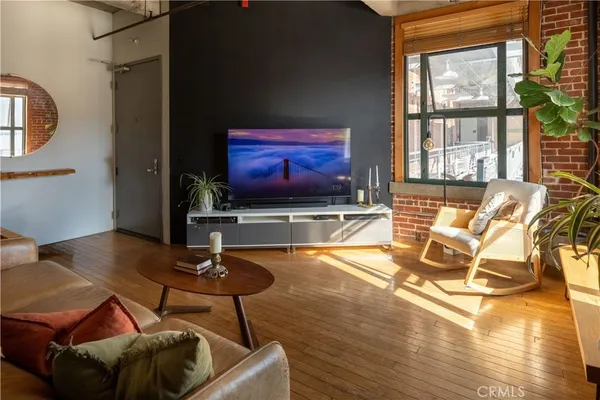 a living room with wooden floor furniture and a fireplace
