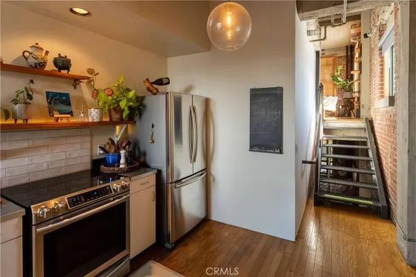 a kitchen with stainless steel appliances a sink and cabinets