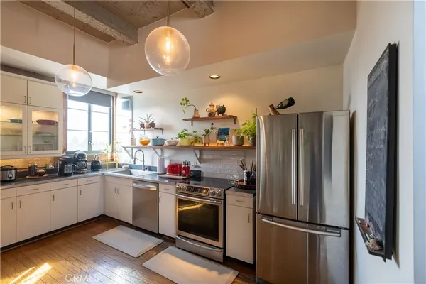 a kitchen with stainless steel appliances a sink a stove and a microwave