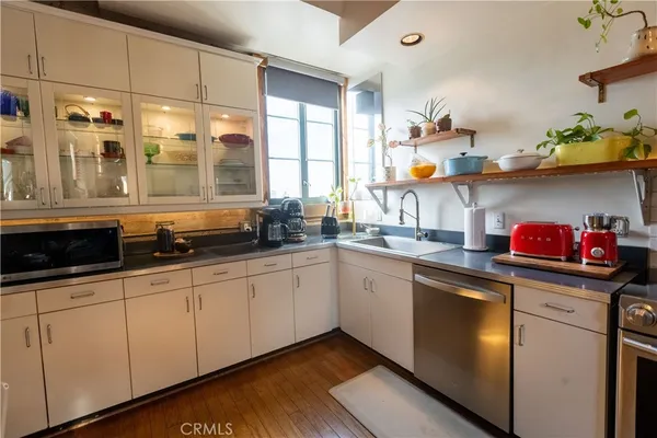 a room with table chairs and mirrors