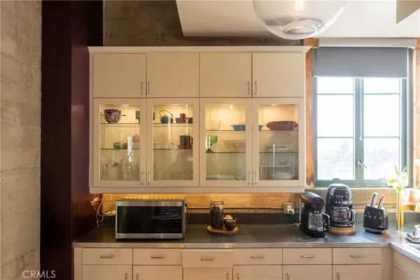 a bedroom with a bed a mirror and a window