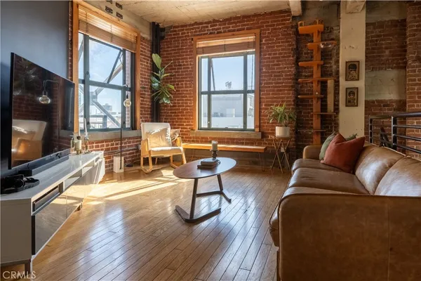 a view of a patio with couches chairs and wooden floor