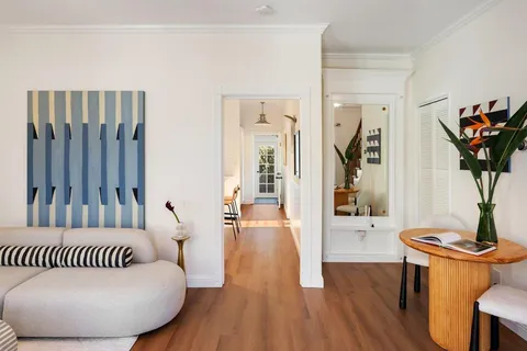 a bedroom with furniture and a wooden floor