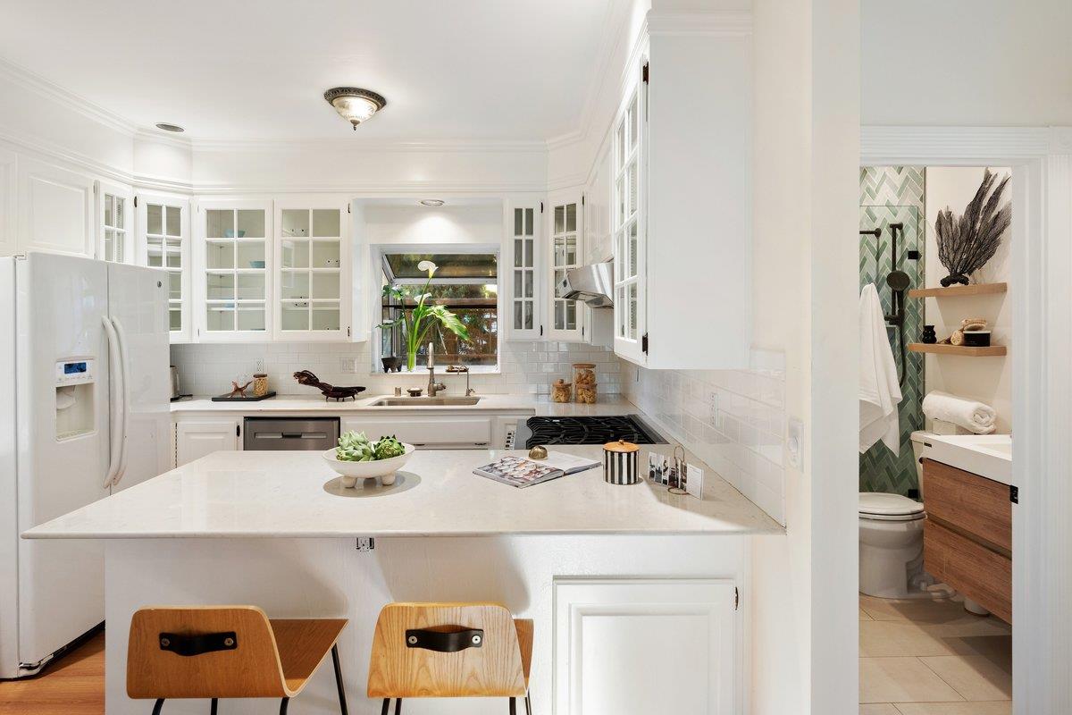 769 Jackson Street Santa Clara, CA 95050 - Photo 9 of 40 a kitchen with a sink a stove and a refrigerator with wooden floor