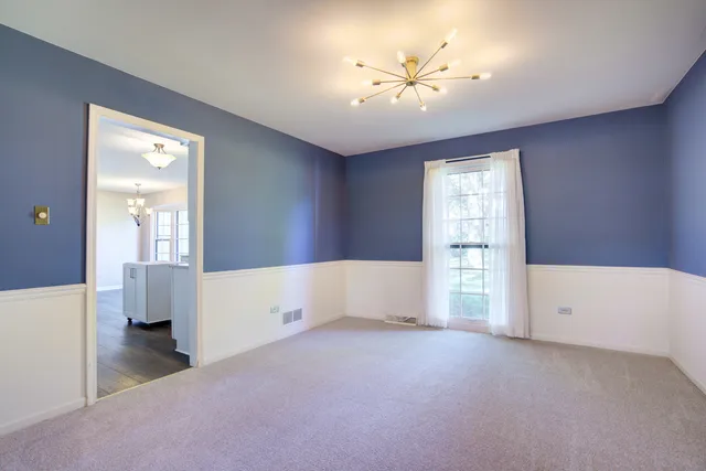 a living room with furniture and a lamp