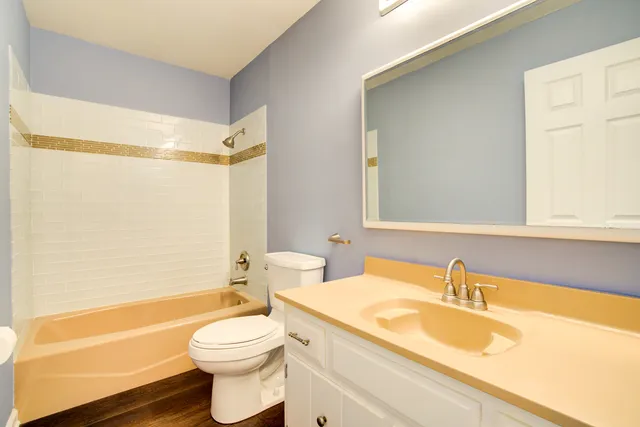 a view of a house with backyard and trees