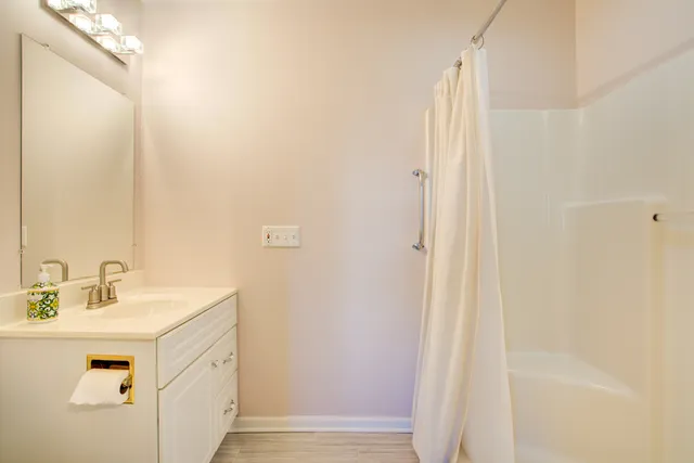 a view of a tennis ground with large trees