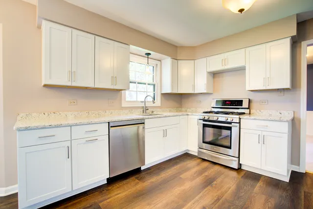 a view of a dining room with furniture large window and wooden floor