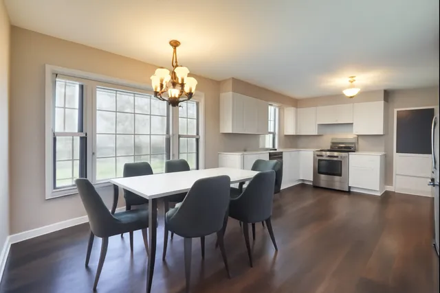a view of a dining room with furniture and chandelier