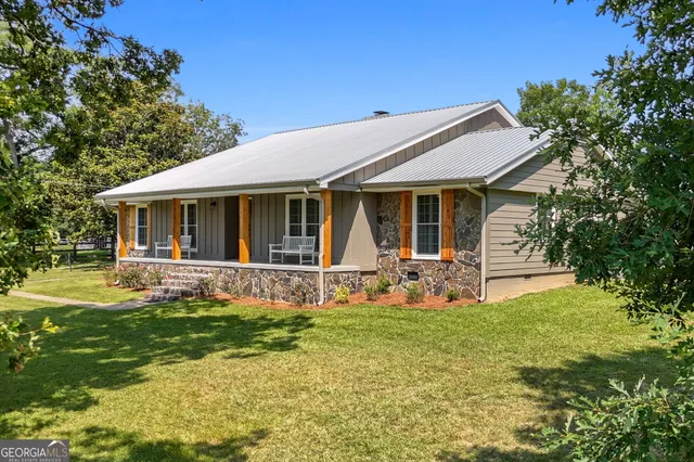 a front view of house with yard and green space