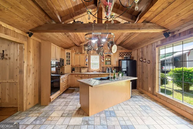 a kitchen with stainless steel appliances granite countertop a sink and a refrigerator