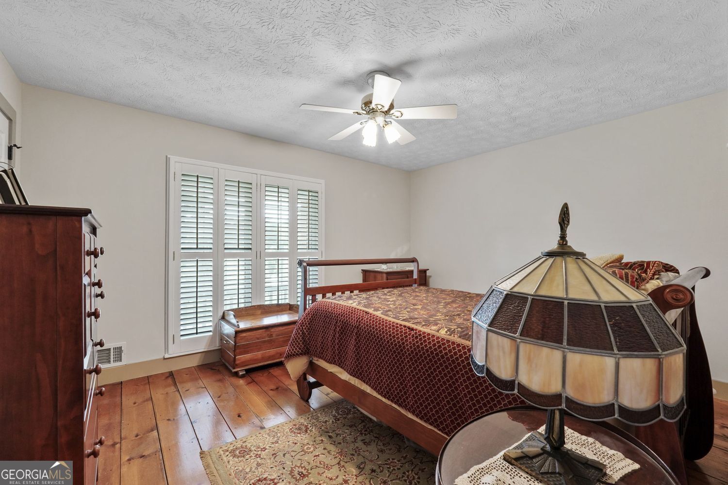 8272 Old Zebulon Road Molena, GA 30258 - Photo 26 of 53 a bedroom with a bed and a chandelier