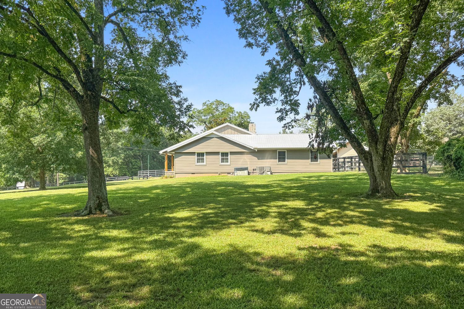 8272 Old Zebulon Road Molena, GA 30258 - Photo 42 of 53 a view of a house with a big yard and large trees