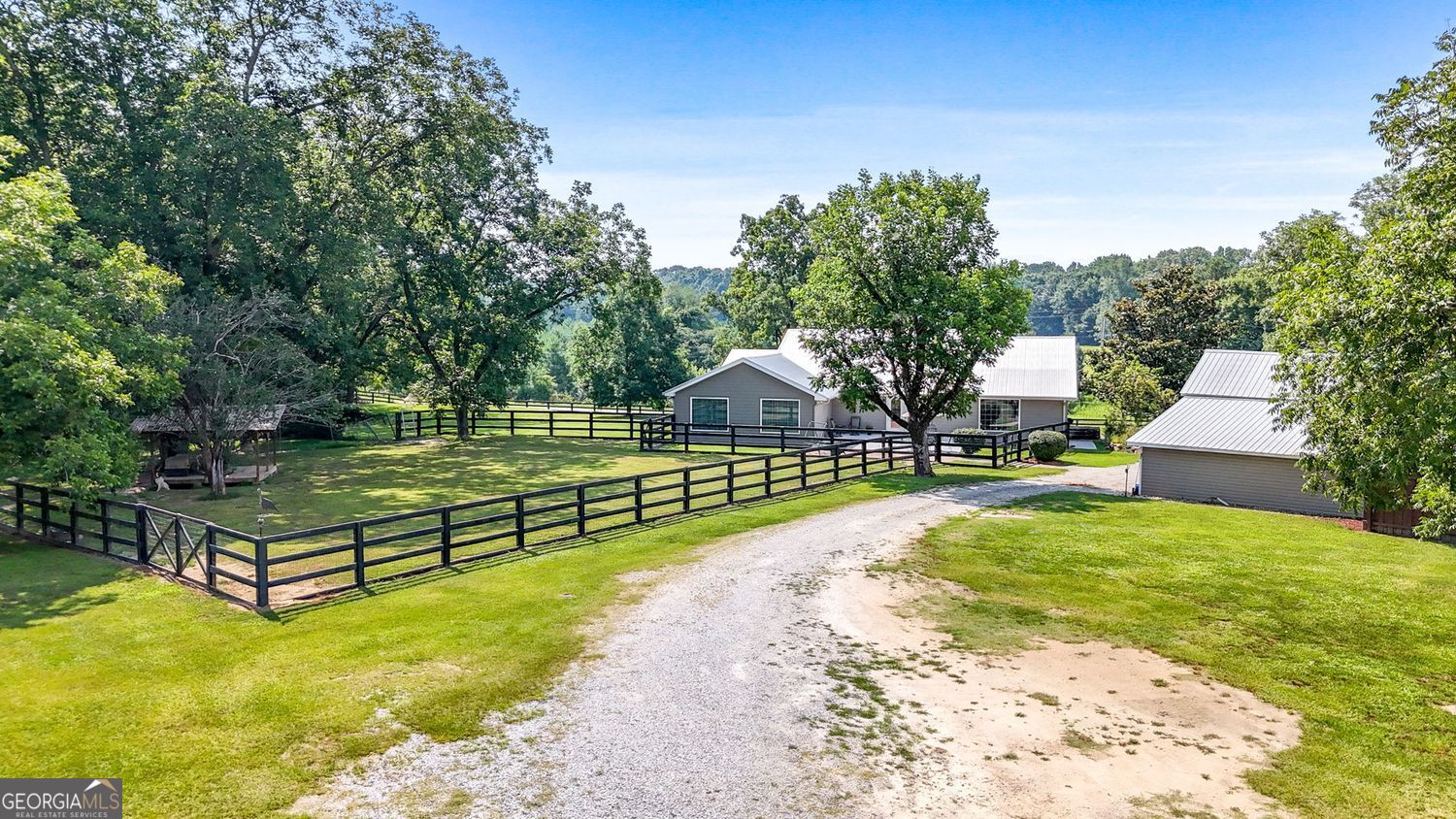 8272 Old Zebulon Road Molena, GA 30258 - Photo 44 of 53 a view of a swimming pool with a bench and trees around