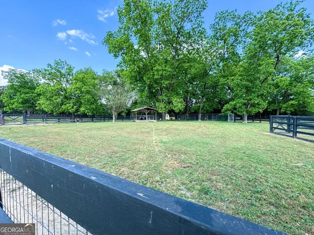 a backyard of a house with lots of green space