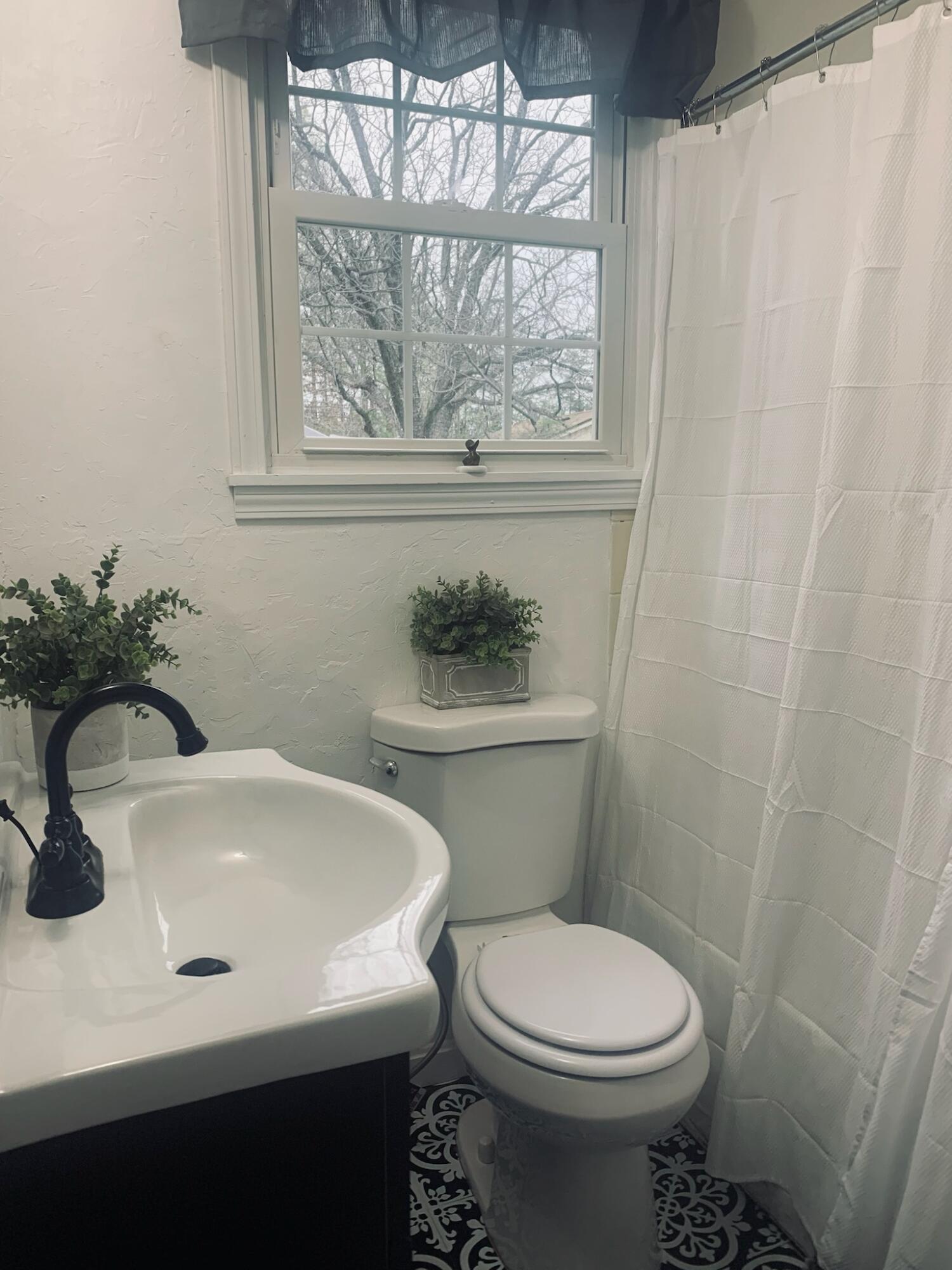 2562 Sandy River Road Axton, VA 24054 - Photo 13 of 26 a bathroom with a sink a toilet and a window