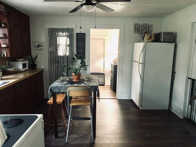 2562 Sandy River Road Axton, VA 24054 - Photo 9 of 26 a kitchen with a table chairs refrigerator and microwave