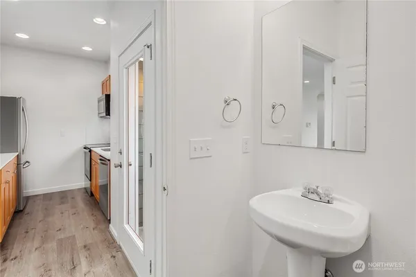 a bathroom with a sink a toilet and mirror