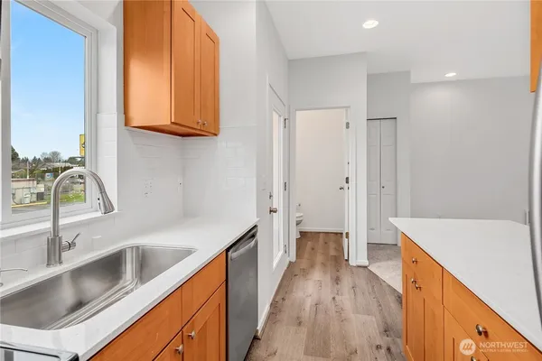 a kitchen with stainless steel appliances granite countertop a sink and a refrigerator