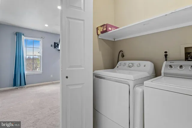 a view of storage and utility room with washer and dryer