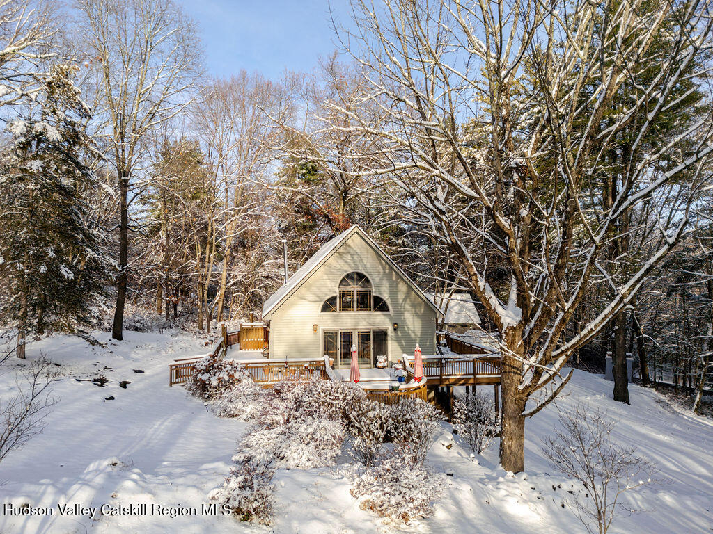 a white house sitting in middle of forest