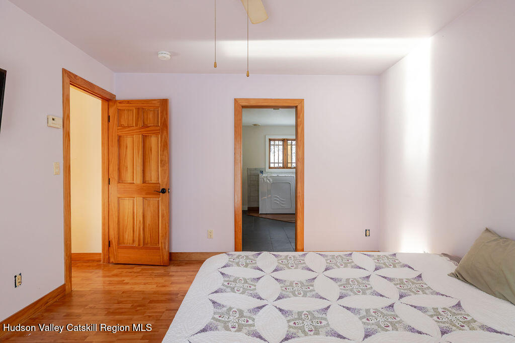 53 Snyder Pond Road Copake, NY 12516 - Photo 11 of 47 a bedroom with a bed and a dresser