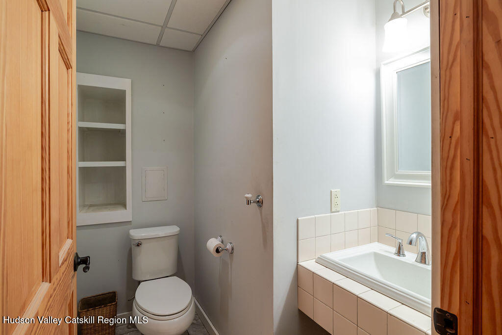 53 Snyder Pond Road Copake, NY 12516 - Photo 22 of 47 a white toilet sitting next to a bathroom sink