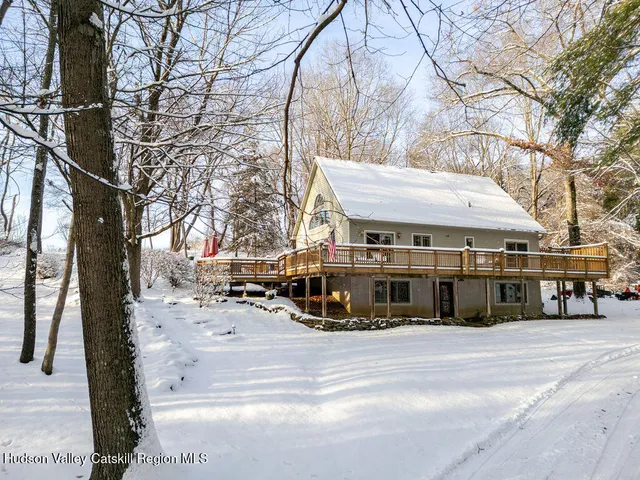a view of a hall with wooden floor and a rug