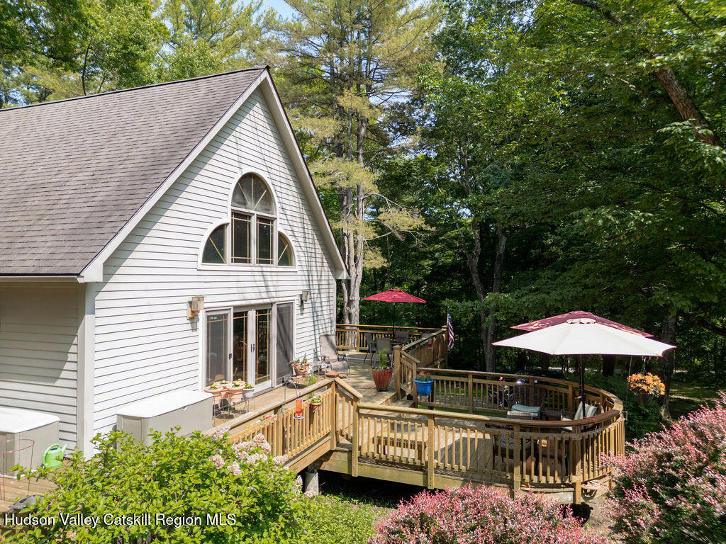 53 Snyder Pond Road Copake, NY 12516 - Photo 34 of 47 a view of a dinning table and chairs under an umbrella
