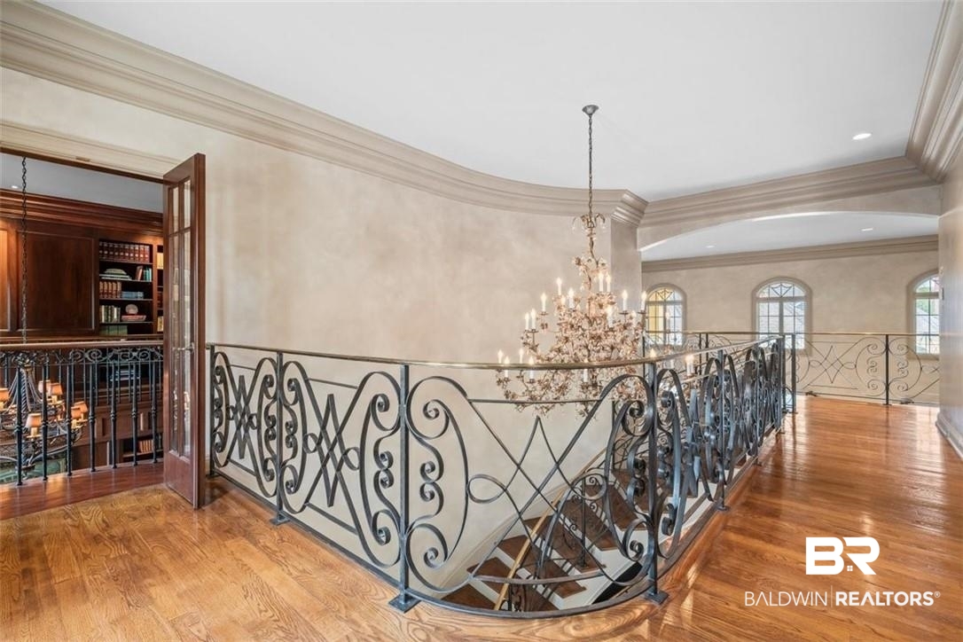 4 Chancery Court Mobile, AL 36608 - Photo 8 of 54 Hallway with wood-type flooring, a chandelier, and crown molding