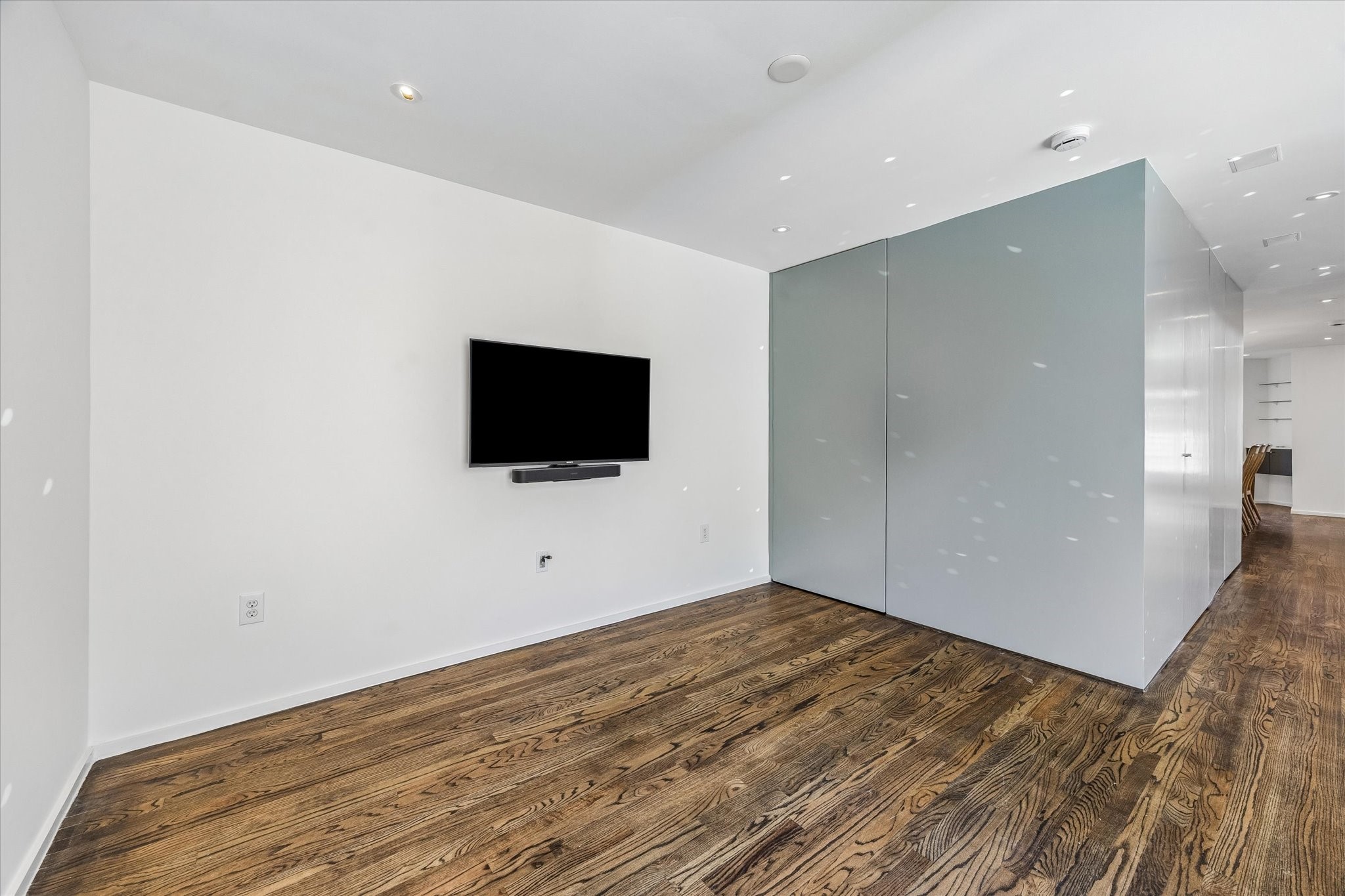 1007 Barkdull Street, Unit 4 Houston, TX 77006 - Photo 15 of 28 Breakfast room. Stairway to third floor Primary Suite is inside the push open door at left (to the right of the TV)