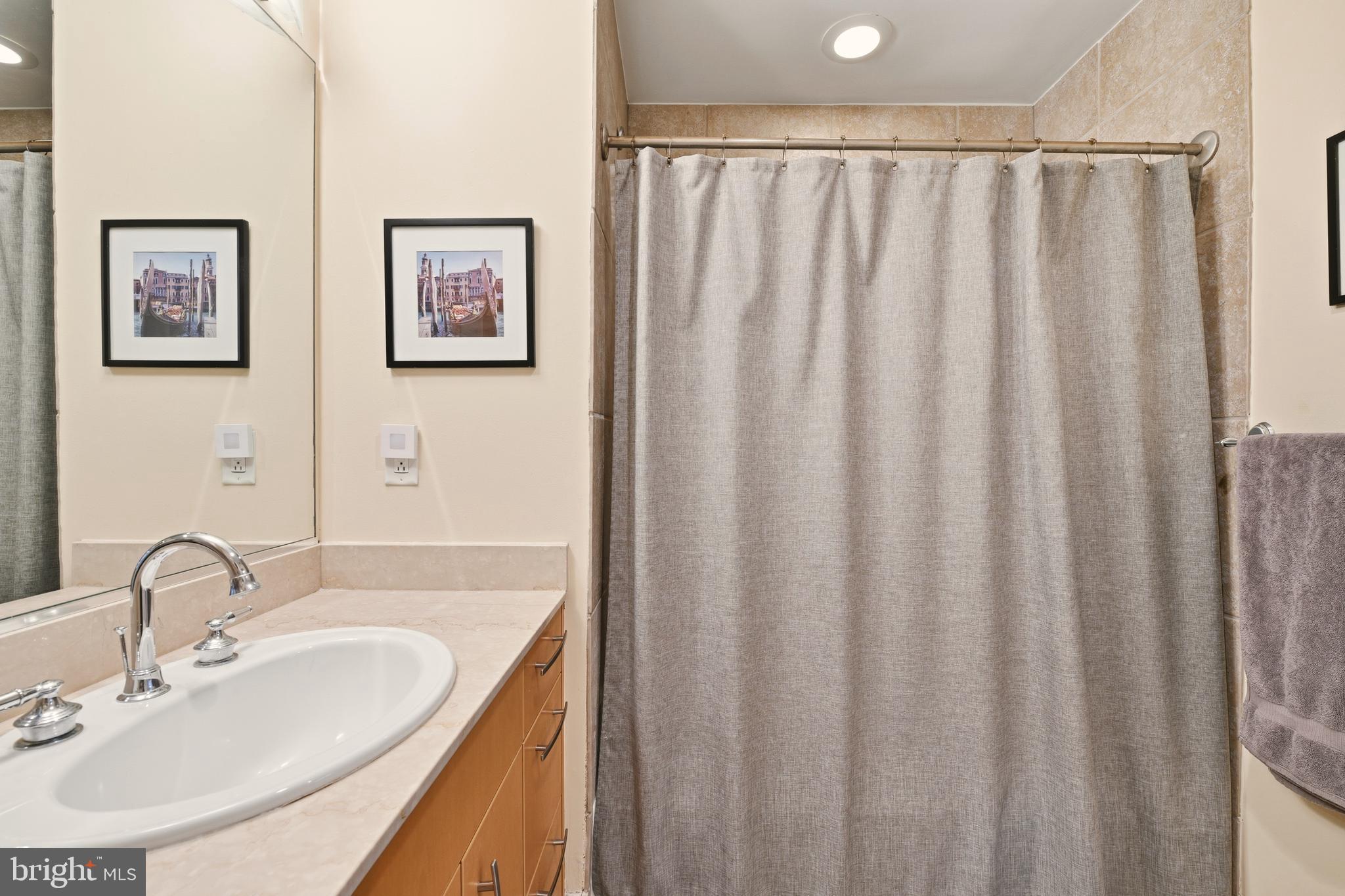 1444 Church Street Northwest, Unit 206 Washington, DC 20005 - Photo 14 of 19 a bathroom with a sink and a mirror