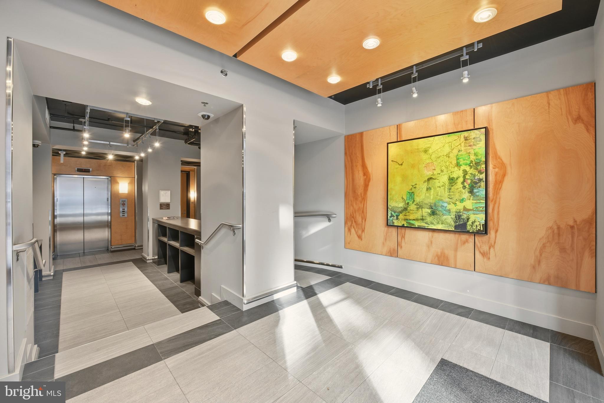 1444 Church Street Northwest, Unit 206 Washington, DC 20005 - Photo 3 of 19 a bathroom with a large mirror vanity and a shower
