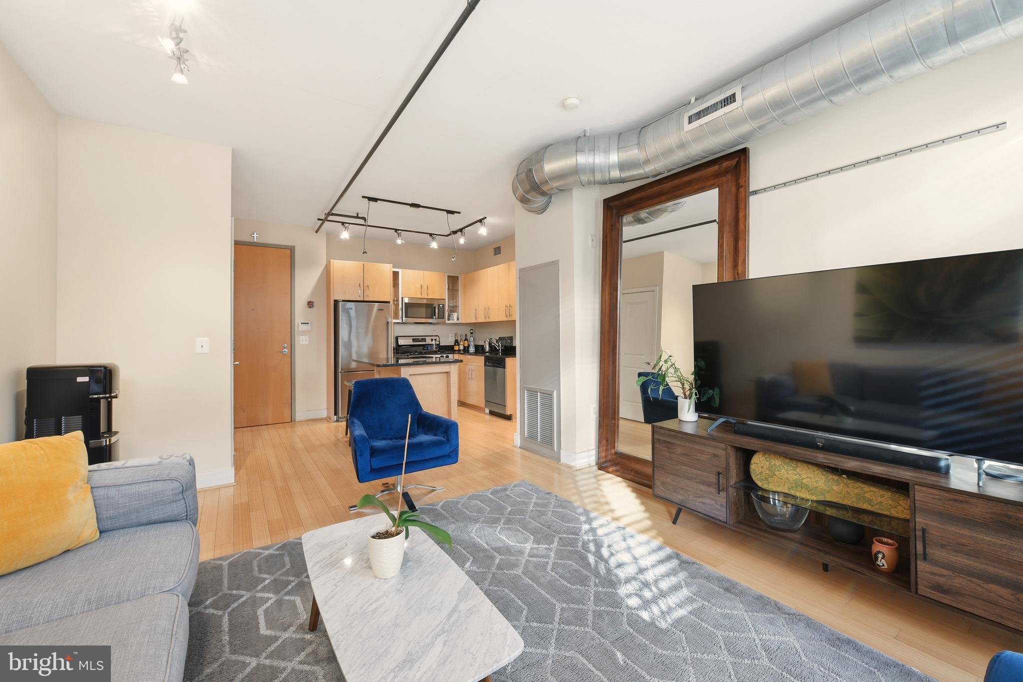 1444 Church Street Northwest, Unit 206 Washington, DC 20005 - Photo 7 of 19 a living room with furniture and a flat screen tv