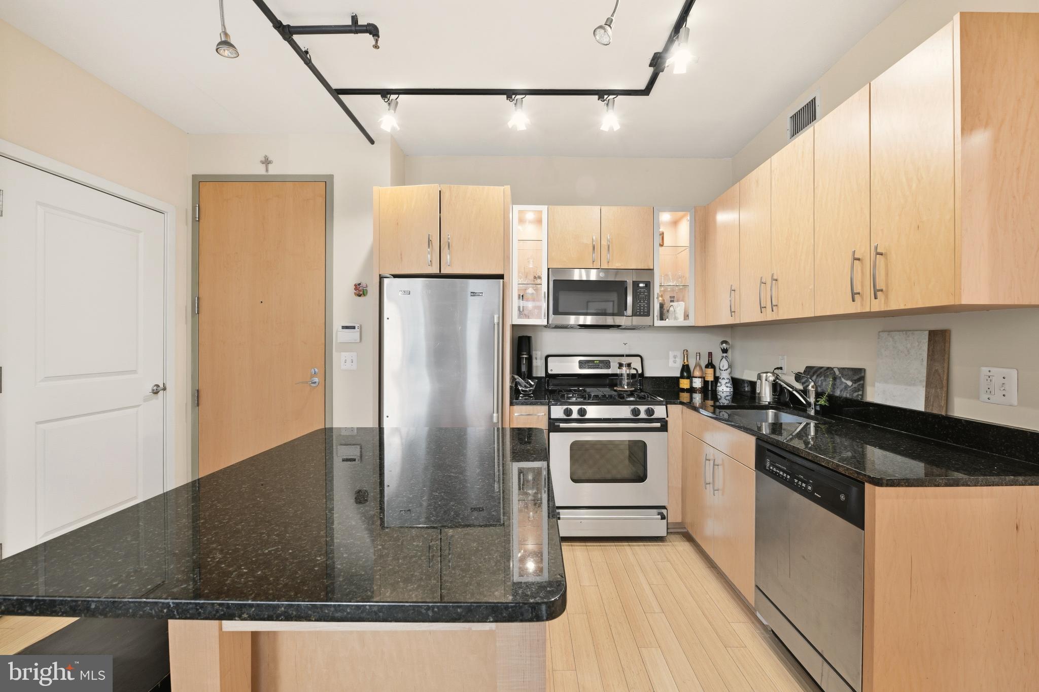1444 Church Street Northwest, Unit 206 Washington, DC 20005 - Photo 10 of 19 a kitchen with stainless steel appliances granite countertop a refrigerator a stove a sink and a microwave