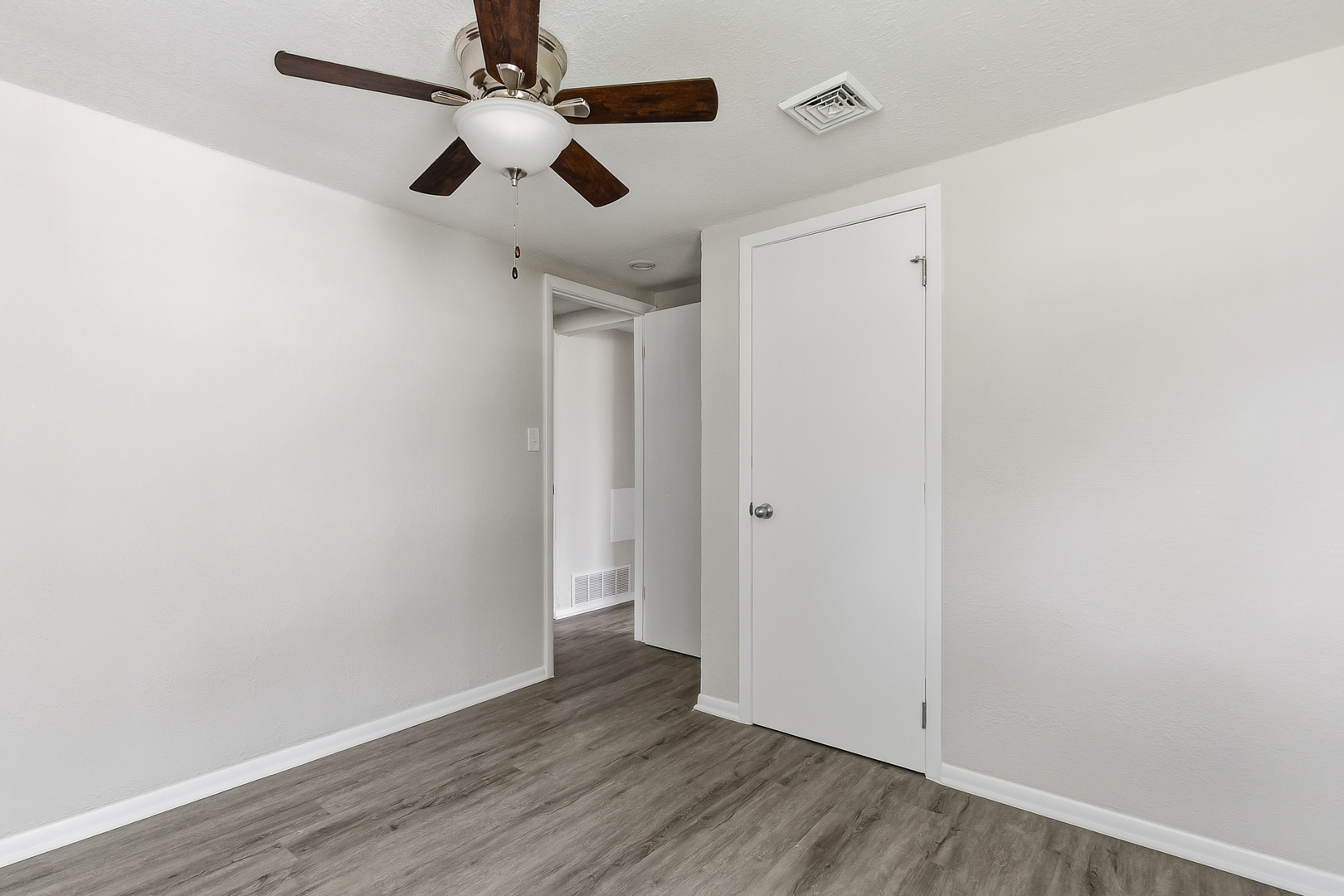 2306 9th Street Silvis, IL 61282 - Photo 29 of 32 an empty room with wooden floor ceiling fan and window