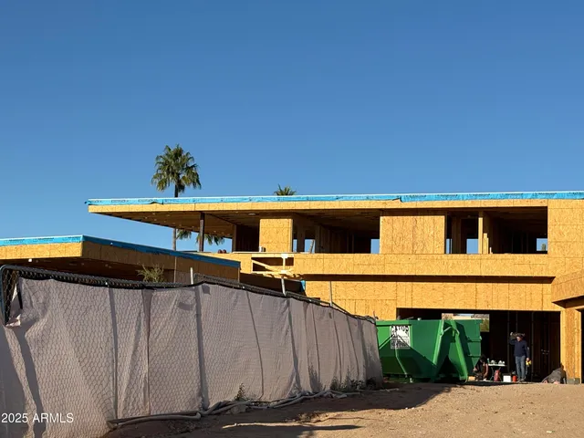 a view of a house with a window and wooden fence