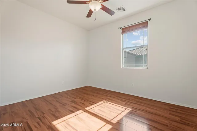 a view of a room with wooden floor and white walls
