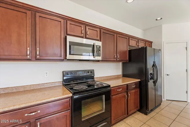 a kitchen with stainless steel appliances granite countertop a stove microwave and refrigerator